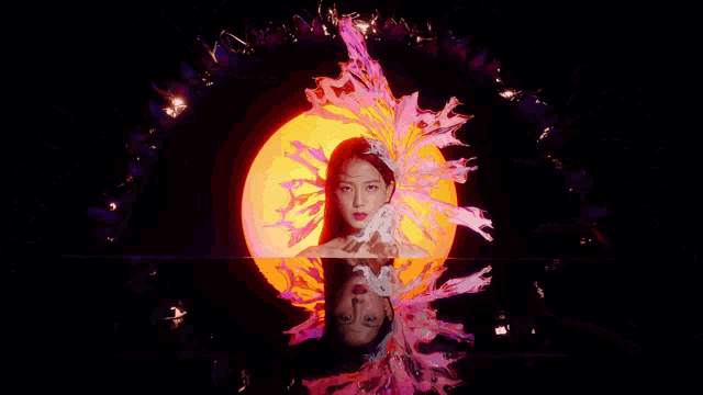 a woman with a pink flower on her head is standing in front of a glowing sun