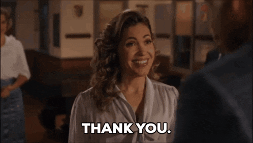 a woman is smiling and says thank you in black letters