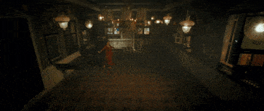 a woman in a red dress is walking down a hallway