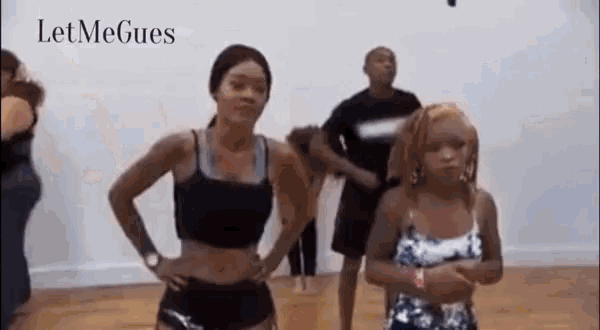 a group of women are dancing together in a room .
