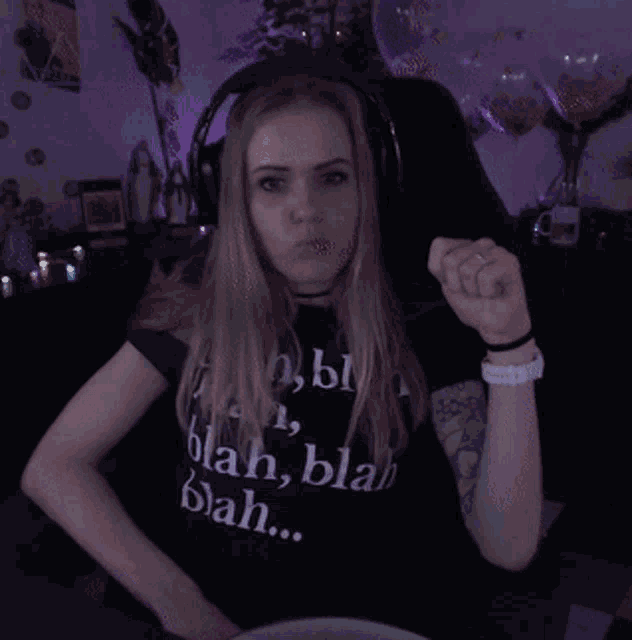 a woman wearing headphones and a shirt that says blah