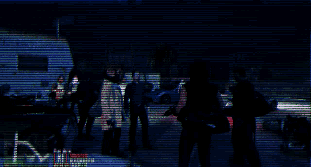 a blurry picture of a group of people standing in a dark room with the letter m visible