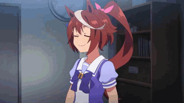 a girl with a ponytail is smiling with her eyes closed in front of a bookshelf