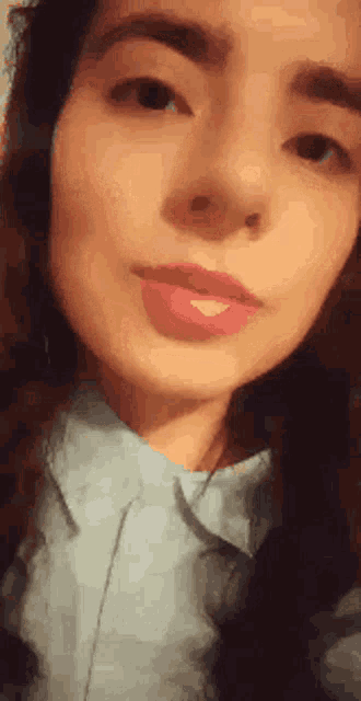 a close up of a woman 's face with red lipstick on her lips