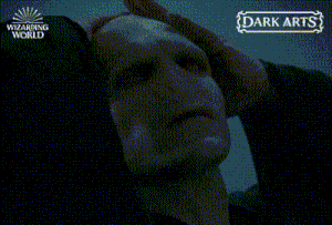 a wizarding world poster with a man holding his head in the dark