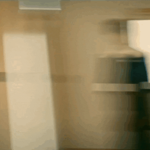 a blurry picture of a person standing in a room