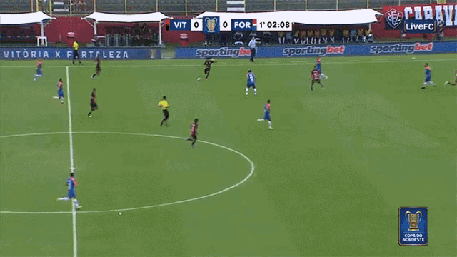 a soccer game is being played on a field with advertisements for sporting bet and vitoria x fortaleza
