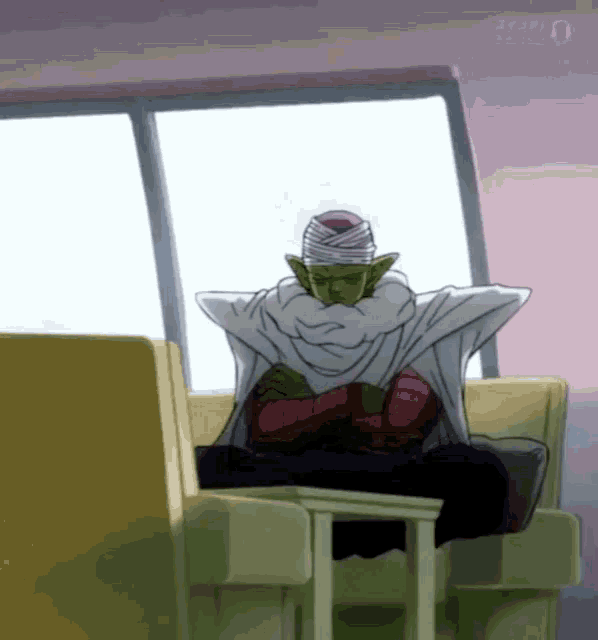 piccolo from dragon ball z is sitting on a couch