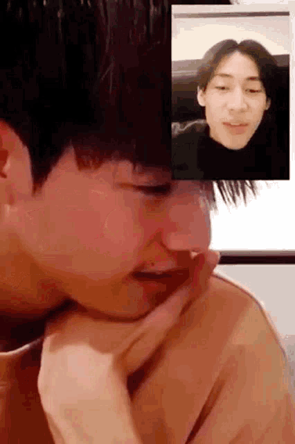 two young men are having a video call with each other and one of them is crying .