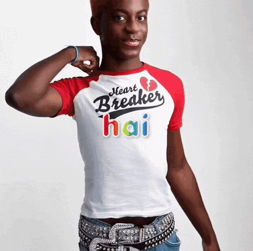 a young man wearing a white shirt that says heart breaker hai