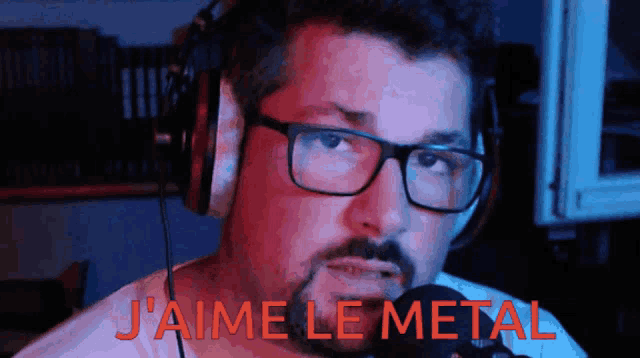 a man wearing glasses and headphones says " j'aime le metal " in red letters