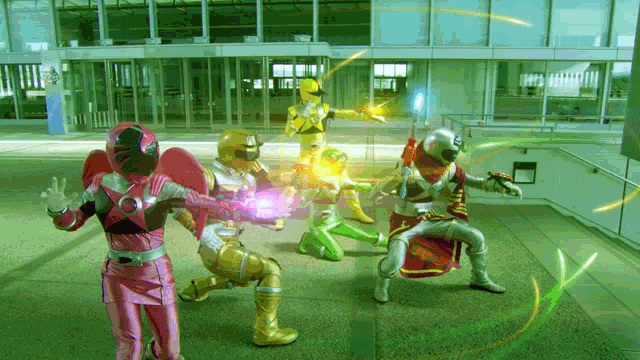 a group of superheros are standing in front of a building and one of them is wearing a pink outfit
