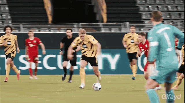 a group of soccer players on a field with a security sign behind them