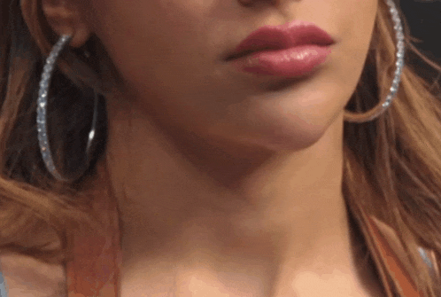 a close up of a woman 's lips and earrings