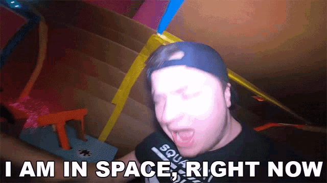 a man in a black shirt with the words i am in space right now on it