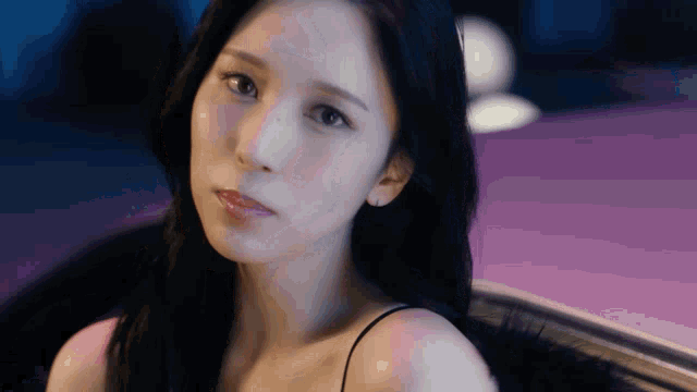 a close up of a woman 's face while sitting in a car .