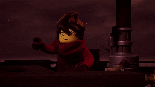 a lego character with a red scarf around his neck stands in a dark room