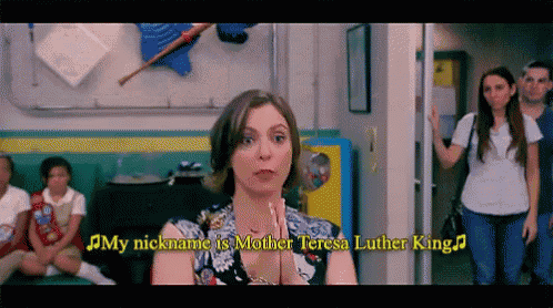 a woman is standing in a hallway with her hands folded and her nickname is mother teresa luther