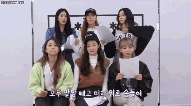 a group of girls are posing for a picture and one of them is wearing a hat that says brooklyn on it