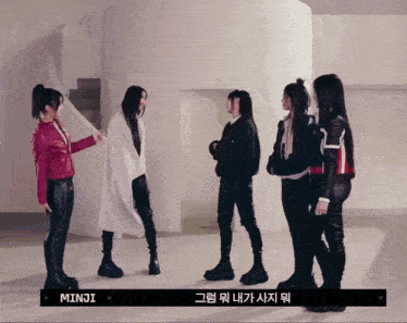 a group of girls standing next to each other with minji written on the bottom right
