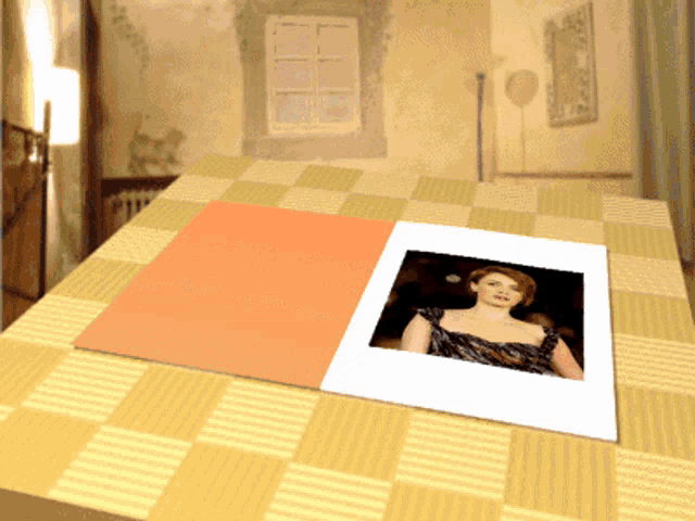 a picture of a woman in a black dress is on a table