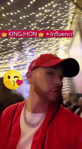 a man wearing a red hat with the name kingjhon written on it