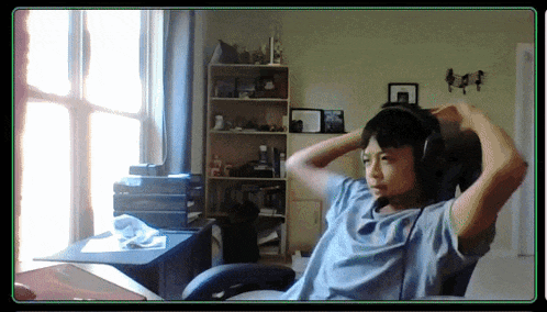 a person wearing headphones is sitting in a chair