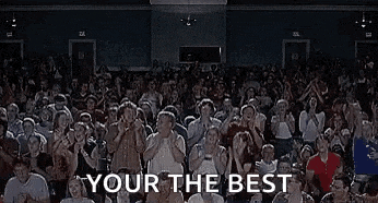 a large crowd of people applauding in a stadium with the words `` eres el mejor your the best '' .