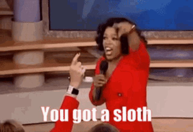 oprah winfrey is giving a middle finger while holding a microphone and says you got a sloth .