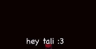 a blurry picture of a person holding a sword with the words `` hey tali : 3 '' written on it .