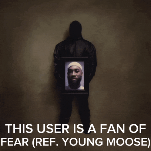 a man is holding a picture of a young moose