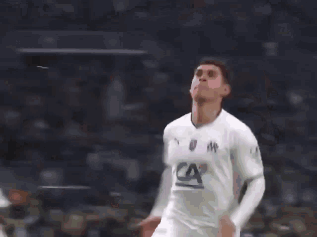 a soccer player wearing a white shirt with the letter ca on it