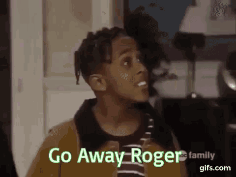a young man is standing in front of a door and says go away roger