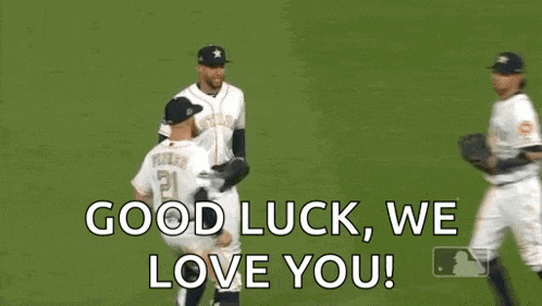 three baseball players are running on a field and saying `` good luck , we love you ! ''