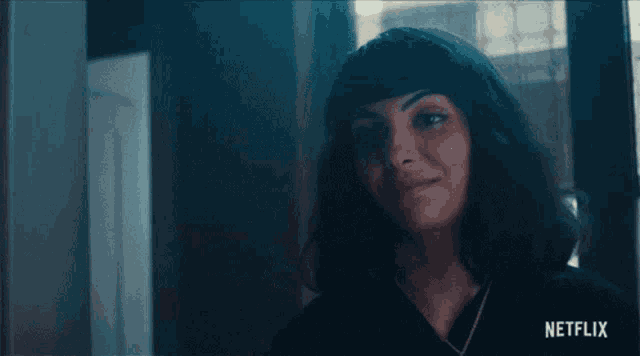 a woman talking on a cell phone with a netflix logo in the corner
