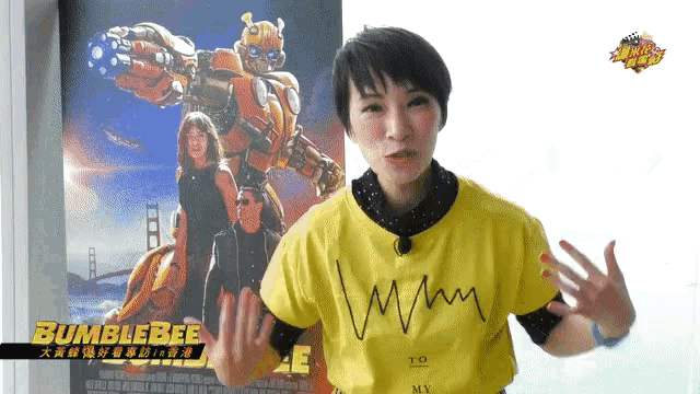 a woman standing in front of a bumblebee poster