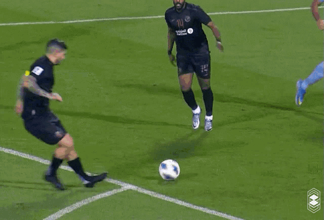 a soccer game is being played on a field with advertisements for neom and molten