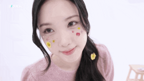 a close up of a girl with flowers on her face