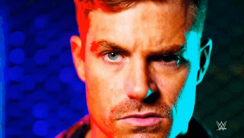 a close up of a man 's face with a colorful background