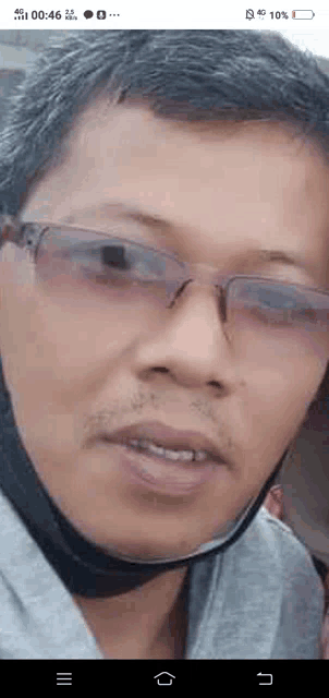 a close up of a man wearing glasses and a mask .