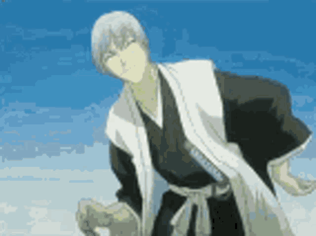 a man in a kimono is standing in front of a blue sky holding a sword .