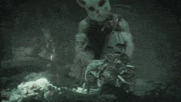 a person wearing a cat mask is holding a bag of flowers