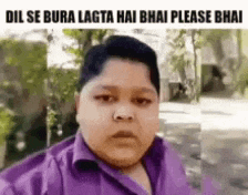 a boy in a purple shirt is taking a selfie with a caption .