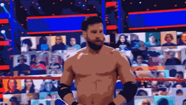 a man without a shirt is standing in a wrestling ring with his hands on his hips