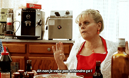 a woman in a red apron says ah non je veux pas entendre ca