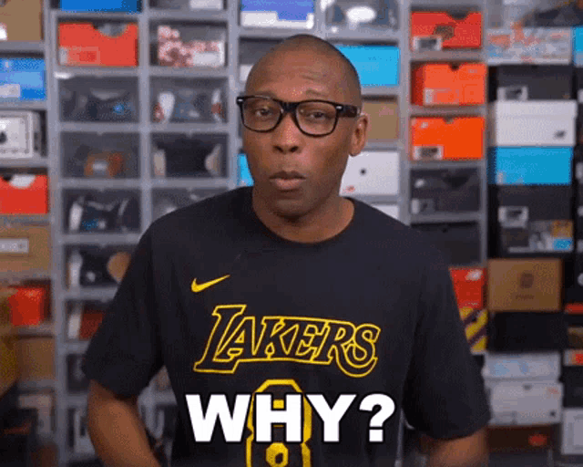 a man wearing a black lakers t-shirt says why