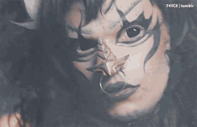 a close up of a person 's face with a ring in their nose and the words t4yce tumblr below it
