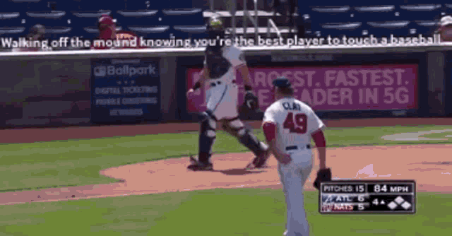 a baseball player with the number 49 on his back is walking off the mound