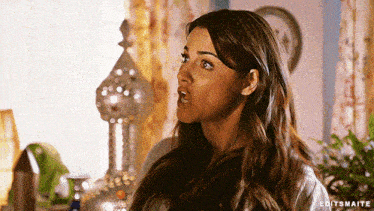 a woman with a surprised look on her face has editsmaite written in the corner