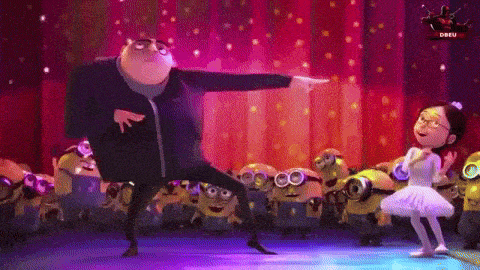 a man and a girl are dancing on a stage with minions behind them